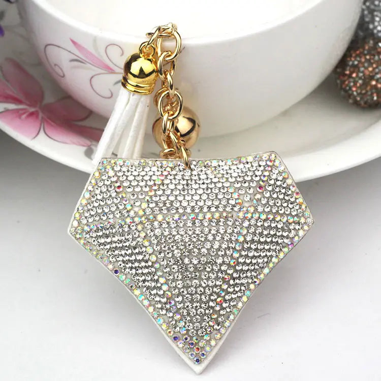 a sparkling diamond-shaped black rhinestone creative tassel bag pendant with clear and iridescent rhinestones, featuring a gold-toned chain and tassel for creative tassel women’s accessories