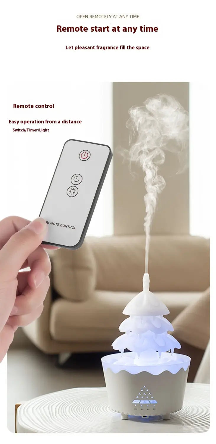 Christmas tree essential oil aroma diffuser humidifier in white tiered design with a soft glowing base and mist rising from the top for effective essential oil aroma use.