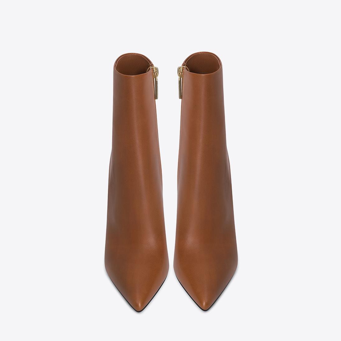 brown leather stiletto ankle boots with pointed toes and gold zippers designed as fashionable ankle boots