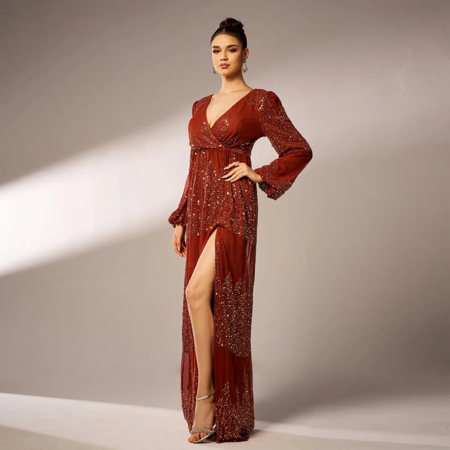 a shimmering burgundy rust bell sleeve sexy long sequined evening dress featuring long sleeves a deep v neckline and sparkling sequin embellishments along the bodice and skirt