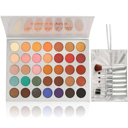 Silver glittery 36 colors eyeshadow palette with vibrant pans and a matching 7pcs makeup brushes set for eye makeup