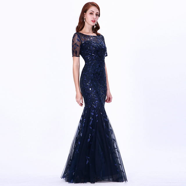 A navy blue temperament mermaid dress featuring intricate gold lace and sequin detailing with sheer short sleeves and a flowing skirt.