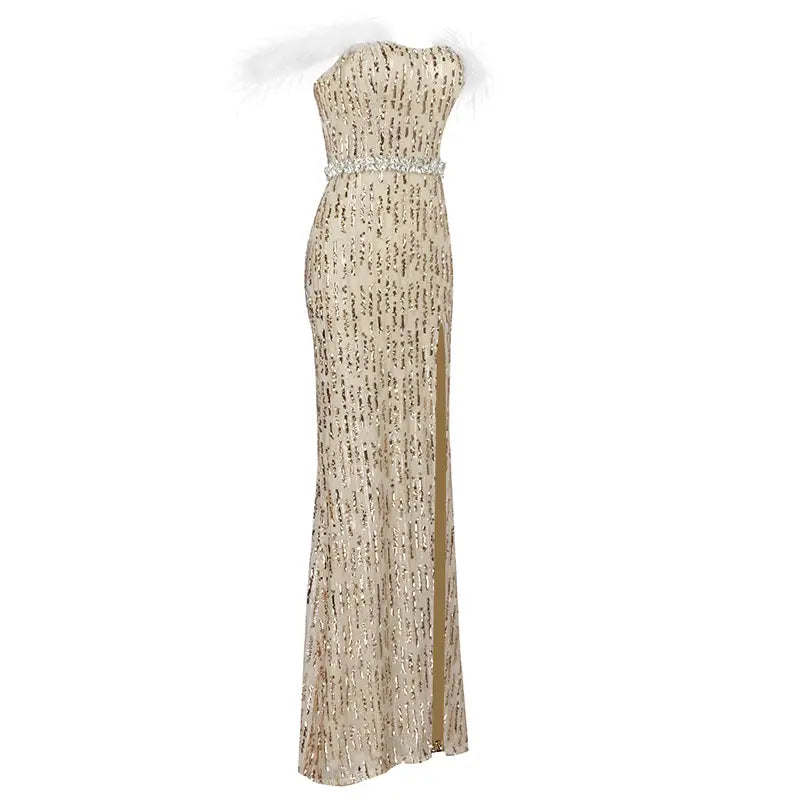 a shimmering gold sequined strapless feather raglan large slit sexy evening dress with a fitted silhouette and a sparkling crystal belt at the waist featuring a high raglan large slit along one side