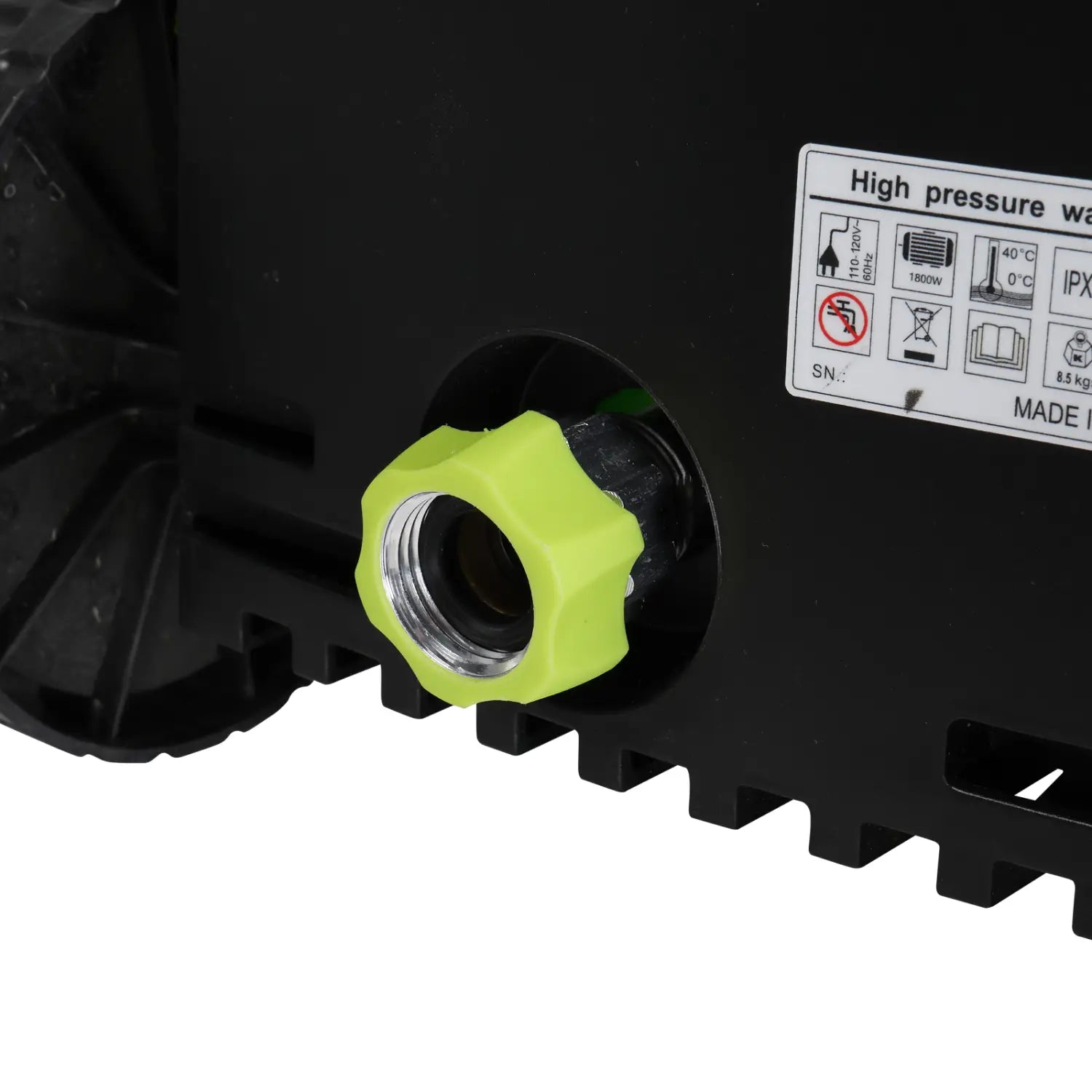 Bright lime green plastic hose connector with metallic threaded interior set into the black body of a green and black high pressure cleaner with coiled hose for high pressure cleaning.