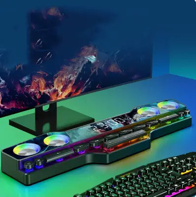 gaming desk lamp with rgb lighting and circular fan design complementing an rgb gaming keyboard with wireless bluetooth speaker multimedia setup.