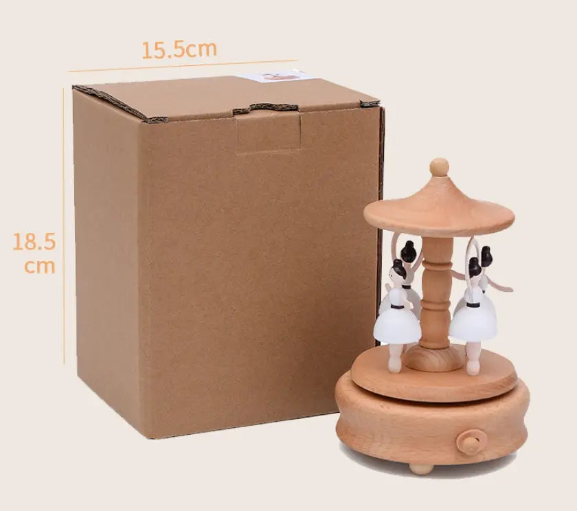 wedding rocking horse wooden rotating music box featuring three white ballerina figurines with black hair on a natural-toned wooden base and canopy.
