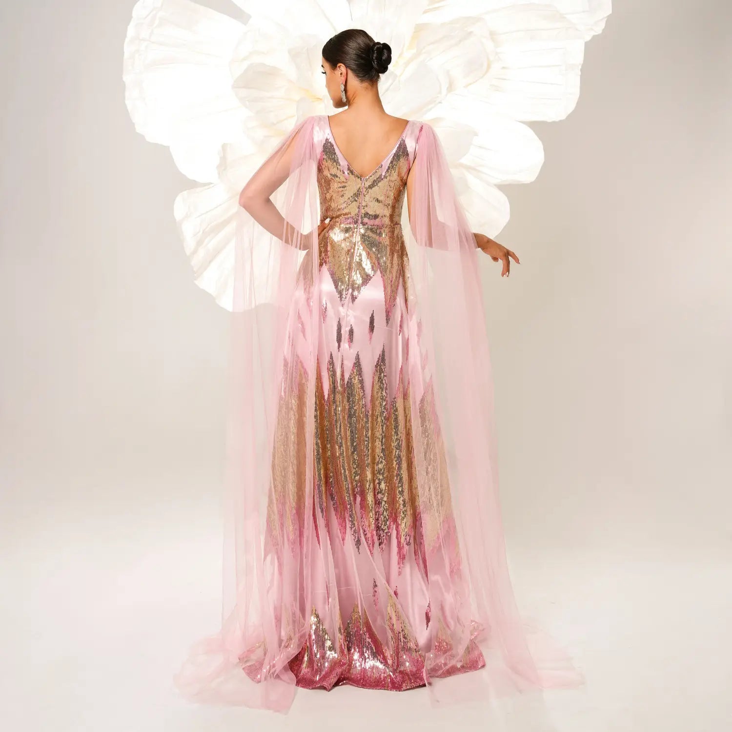 A shimmering pink and gold sequins large swing dress with long sleeve mesh fabric and a flowing sheer overlay.