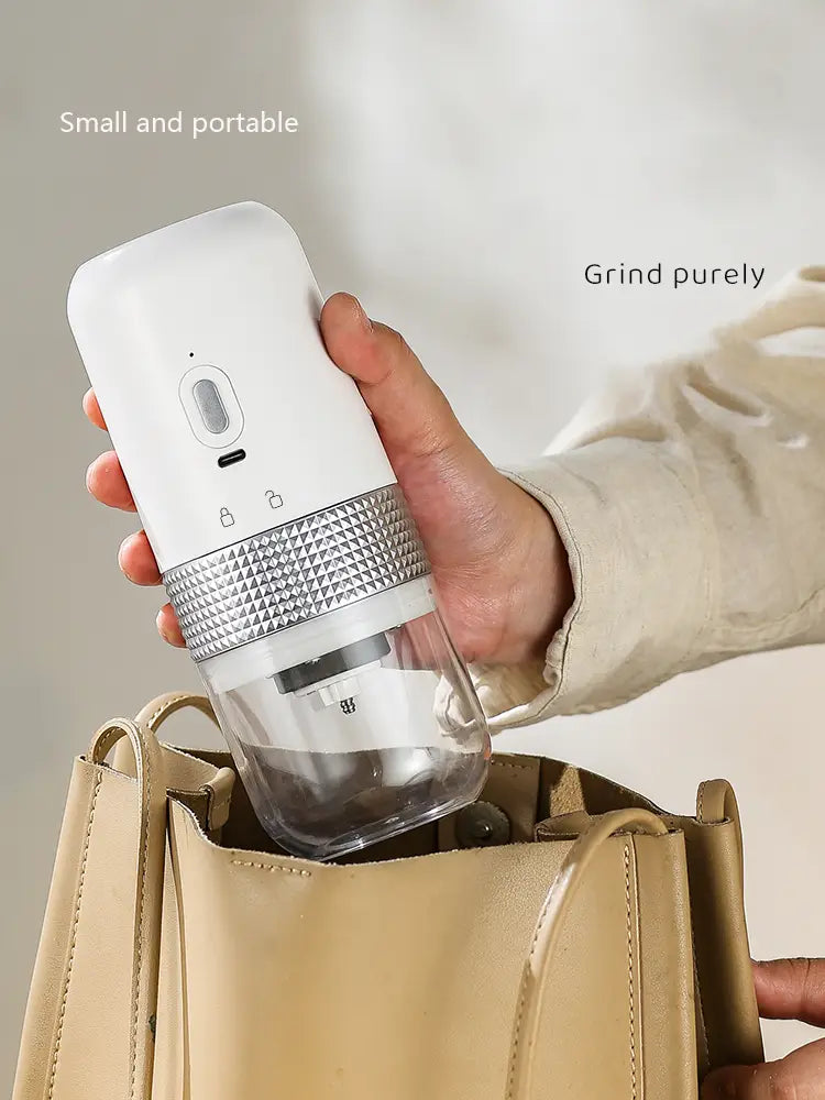 White and transparent portable electric ceramic coffee grinder with USB charging and a textured silver band