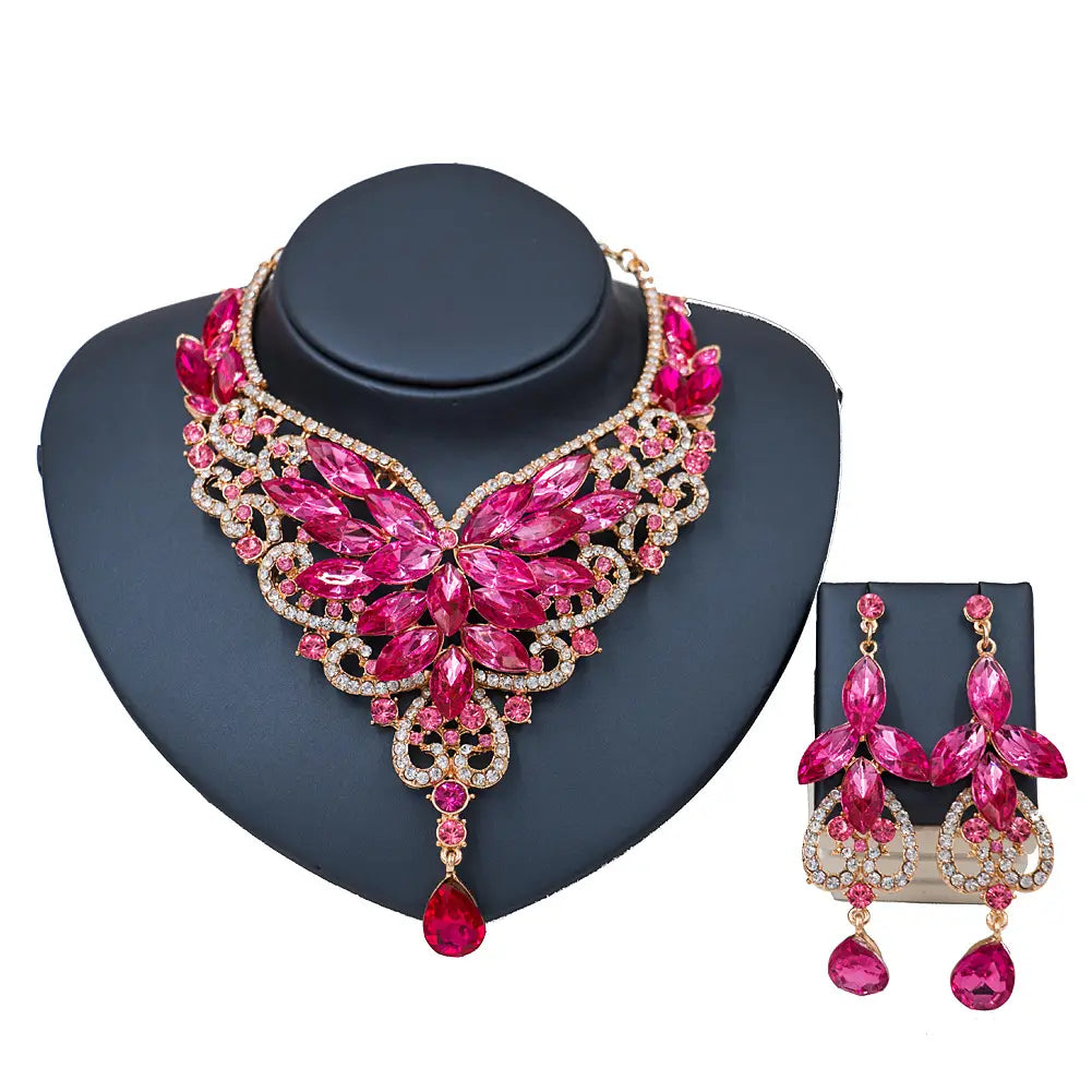 a vibrant fuchsia and rose gold floral necklace set with dangling teardrop pendants from the american color exaggerated bride collection designed for a color exaggerated bride in a speed selling explosion style