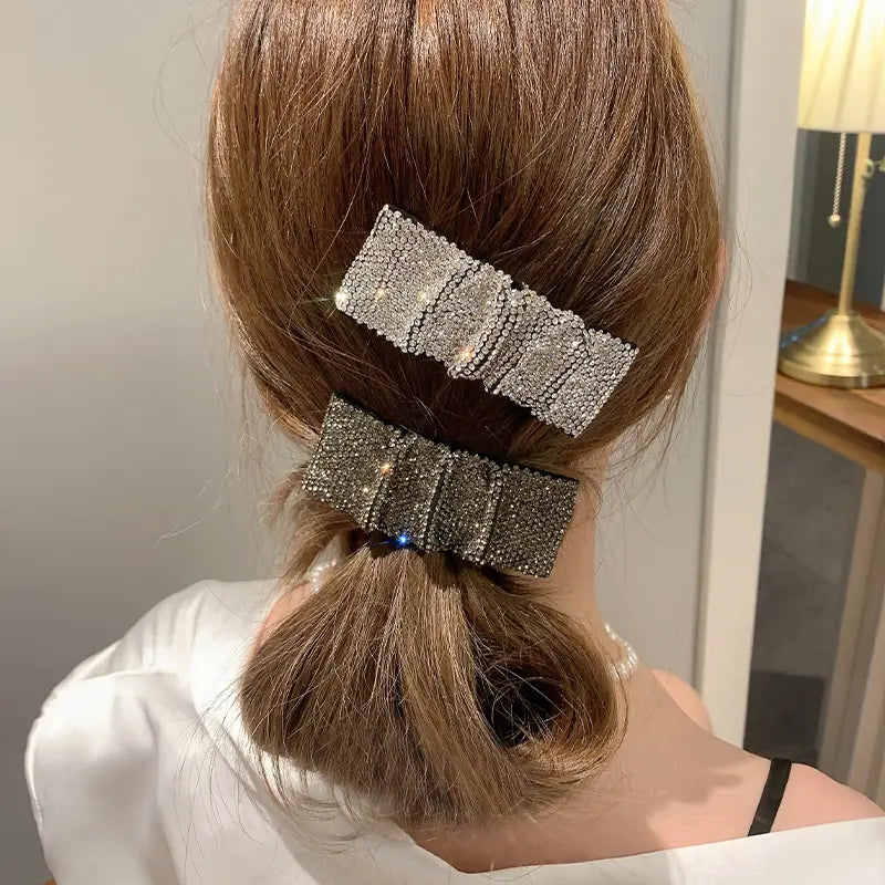 two silver bow pleated bb clips featuring hot rhinestone details and sparkling rhinestone-encrusted design