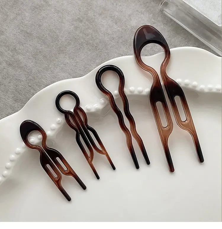 set of five tortoiseshell acrylic hair clips with sleek modern designs and varying fork widths designed as a lazy updo gadget for head bun lazy and bun lazy updo styling.