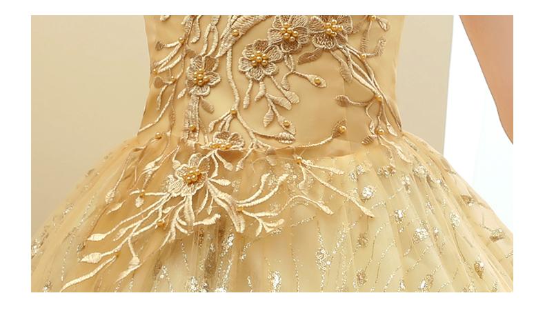a delicate champagne-colored solo performance costume tutu adorned with intricate gold lace embroidery and sparkling beaded floral motifs