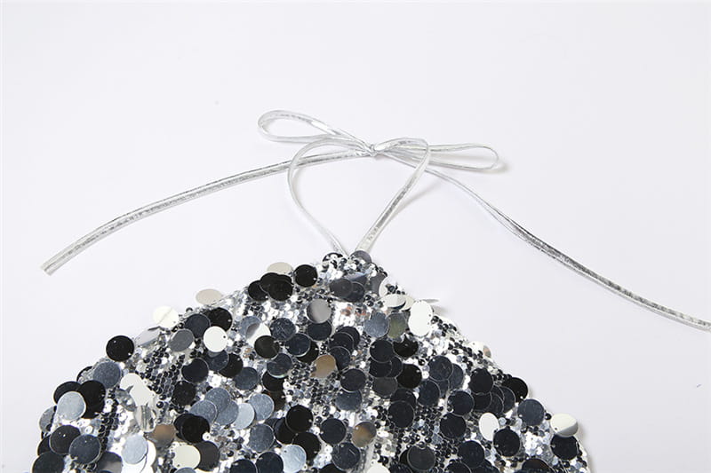 a shimmering black and silver halter backless sequined vest with delicate silver ribbon tie made of sequined fabric