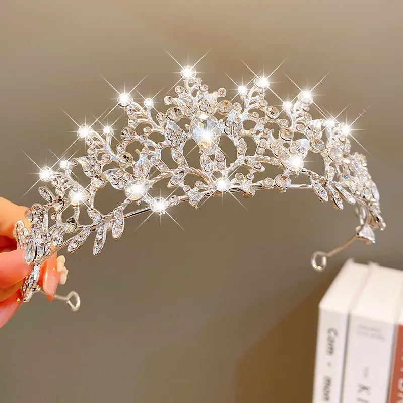 a sparkling silver crown headband from sweet fashion jewelry featuring intricate leaf and floral designs adorned with clear crystals, perfect hair accessories for elegant occasions