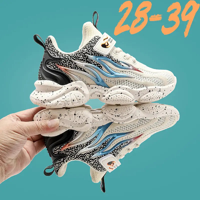 White boys sneakers fashion with black speckles, blue flame-like accents, mesh material, and a chunky sole design.
