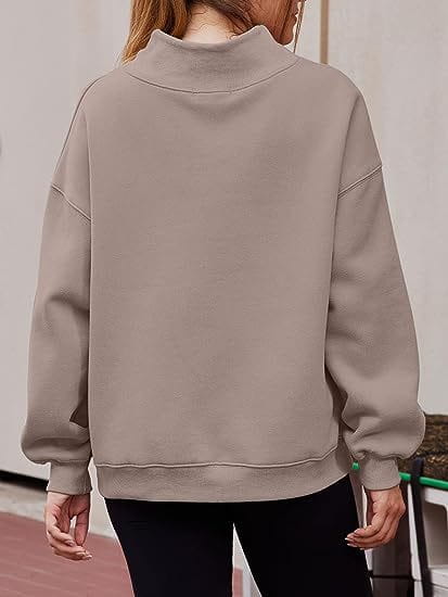 beige solid color pullover sweatshirt solid with a relaxed fit, high neck, and ribbed cuffs designed as a pink oversized turtleneck pullover sweatshirt solid color.