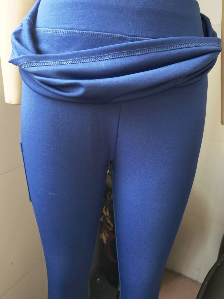 blue high-waisted women tennis skirted leggings with a draped elastic waistband and pockets designed for athletic performance