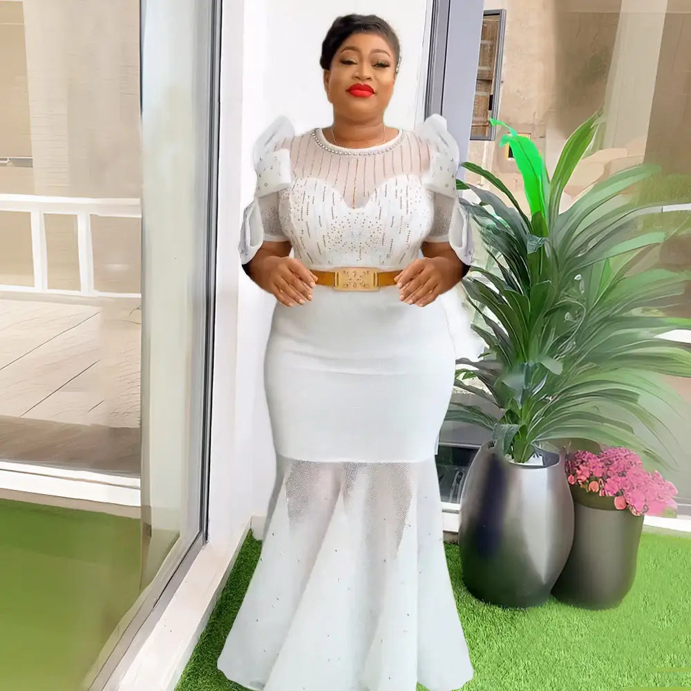 white mermaid-style dress featuring a sheer beaded bodice with puffy short sleeves showcasing heavy embroidered hot diamond beads craftsmanship.