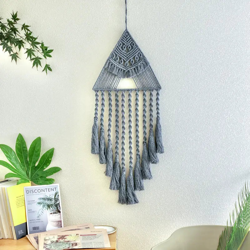 Gray macrame handwoven home decor featuring a home decor triangle with a cascading tassel design for wall hanging in a decor triangle dream style.