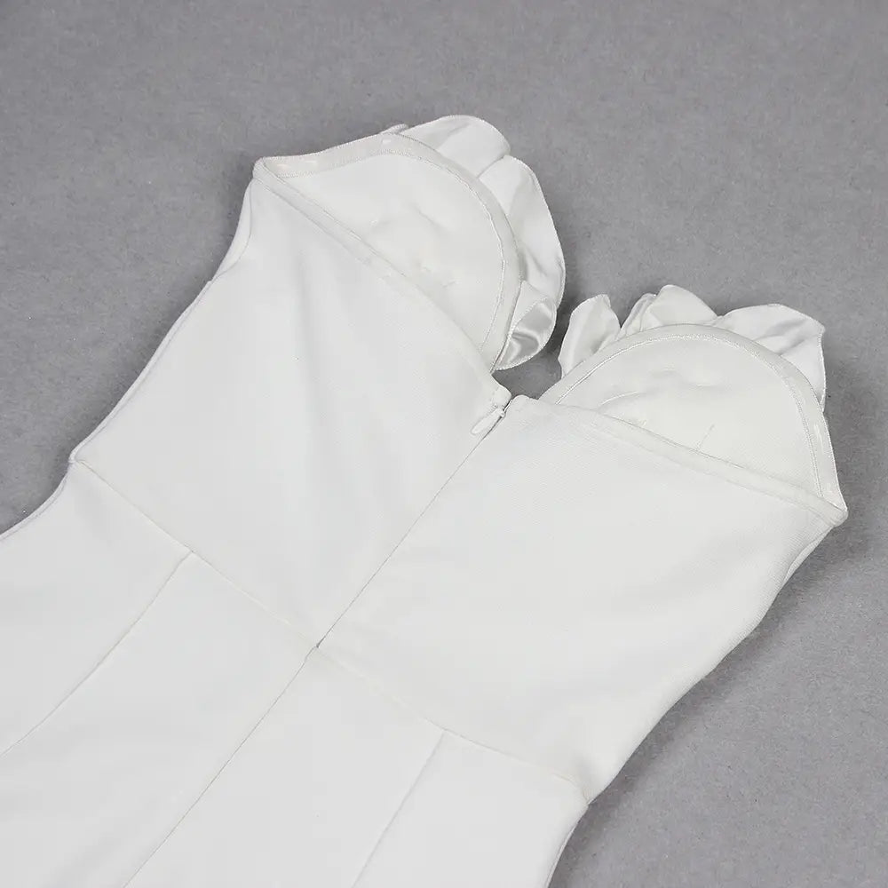 white temperament socialite flower chain evening dress showing the back with a white sleeveless design featuring ruffled shoulder details and a zipper closure