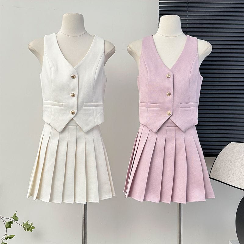 a white and soft pink high waist pleated skirt two-piece set featuring sleeveless v-neck vests with three gold-toned buttons and front pockets