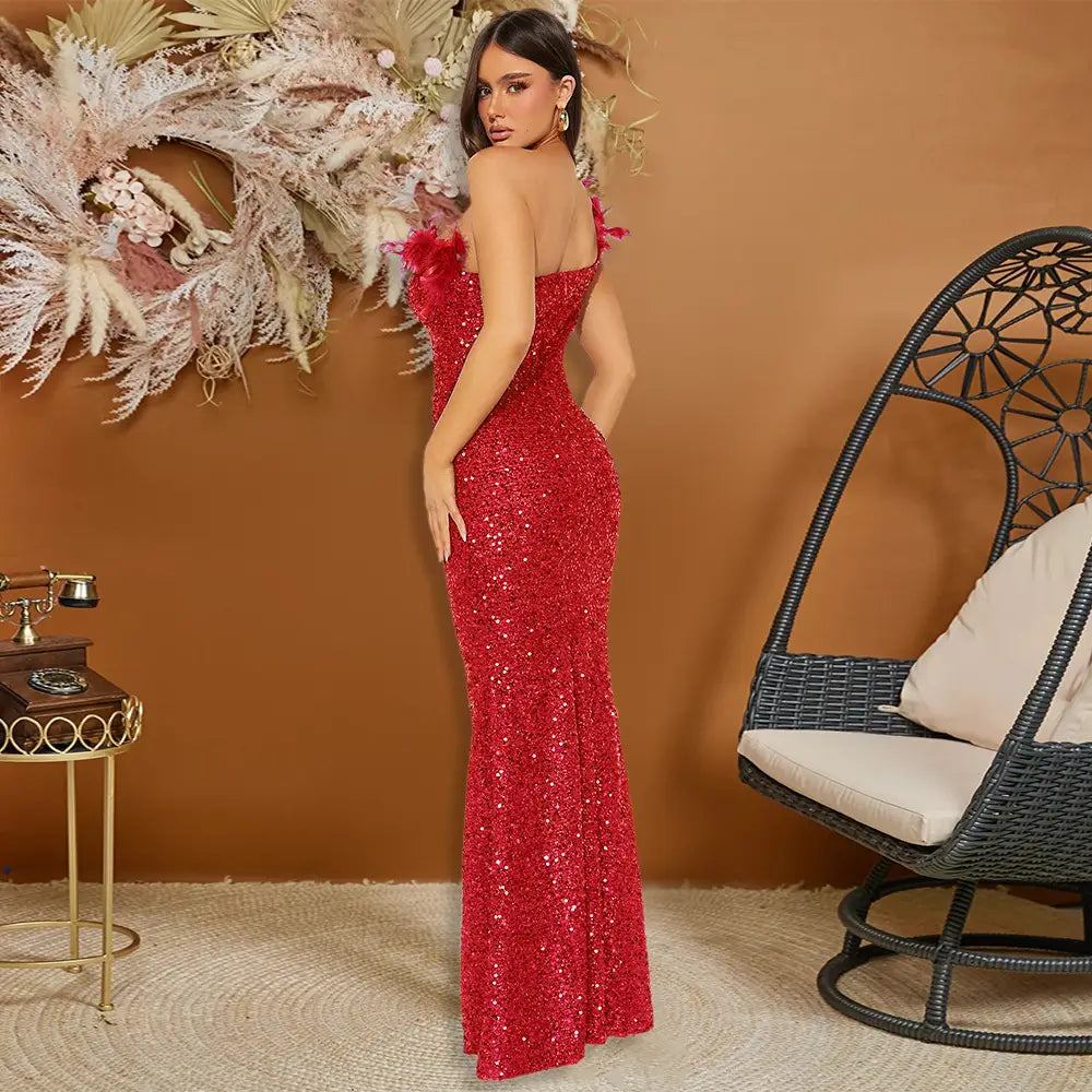 A shimmering red sequined mermaid-style evening dress featuring delicate black paillette feather stitching and feather stitching sequin shoulder accents.