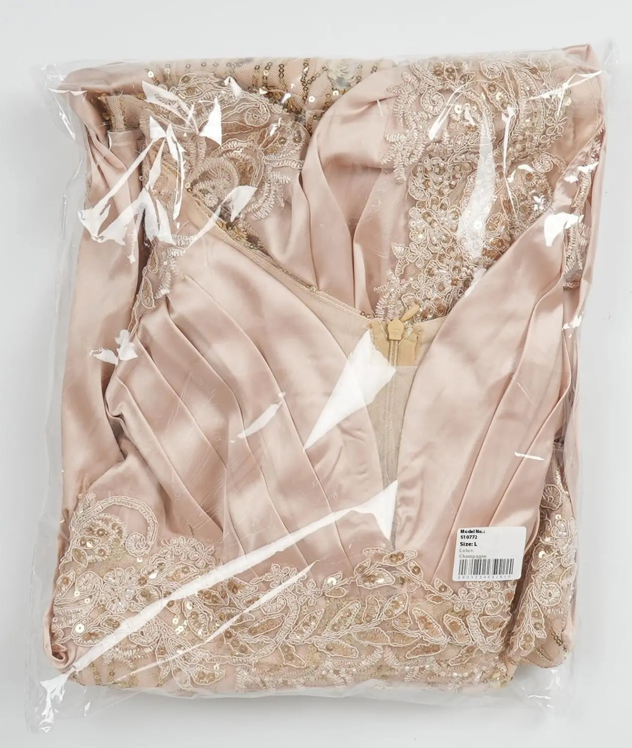 plus size long sleeve sequined evening dress in delicate blush pink satin with intricate gold lace and sequin detailing packaged in clear plastic.