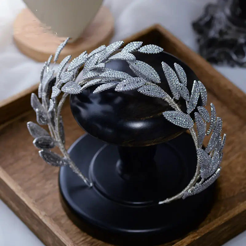 Silver leaf zircon alloy hair band featuring an alloy hair band design adorned with sparkling artificial zircon alloy crystals.