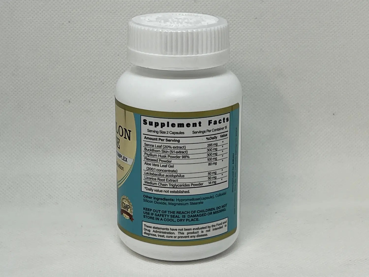 white plastic bottle with white ribbed cap and teal label showing supplement facts for senna leaf and buckthorn skin extract on the back of super colon cleanse capsule 30 count for detox and digestive health