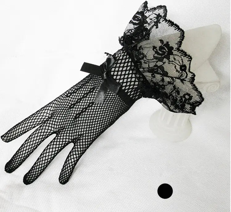 black fishnet stretch mesh gloves with intricate lace cuffs and a decorative bow at the wrist made from knitted stretch mesh material.