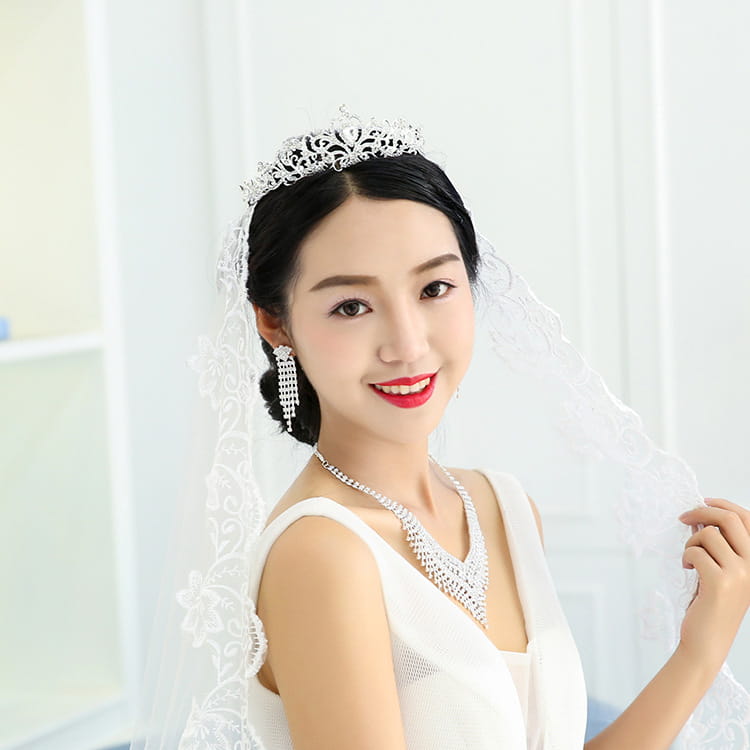 Silver tiara with intricate filigree design and american rhinestone claw chain featuring sparkling rhinestone claw chain large accents.