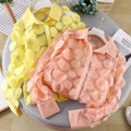Yellow and peach sheer flower chiffon gauzy shirt with circular layered ruffle embellishments in delicate peach-colored chiffon