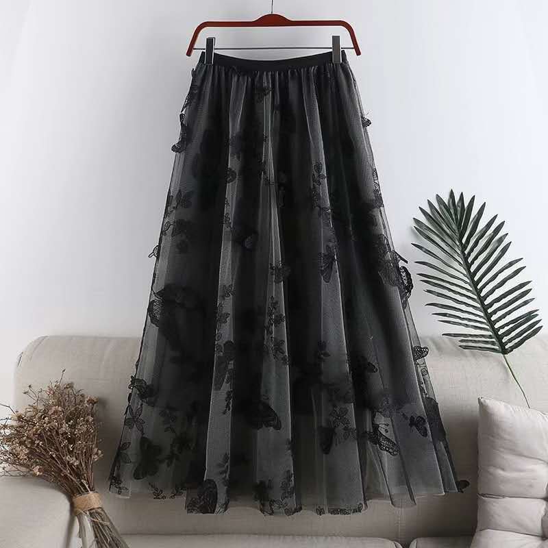 black sheer tulle mid-length skirt with a high-waisted elastic band and delicate butterfly embroidery featuring embroidered bow lace detailing in a bow lace mesh design