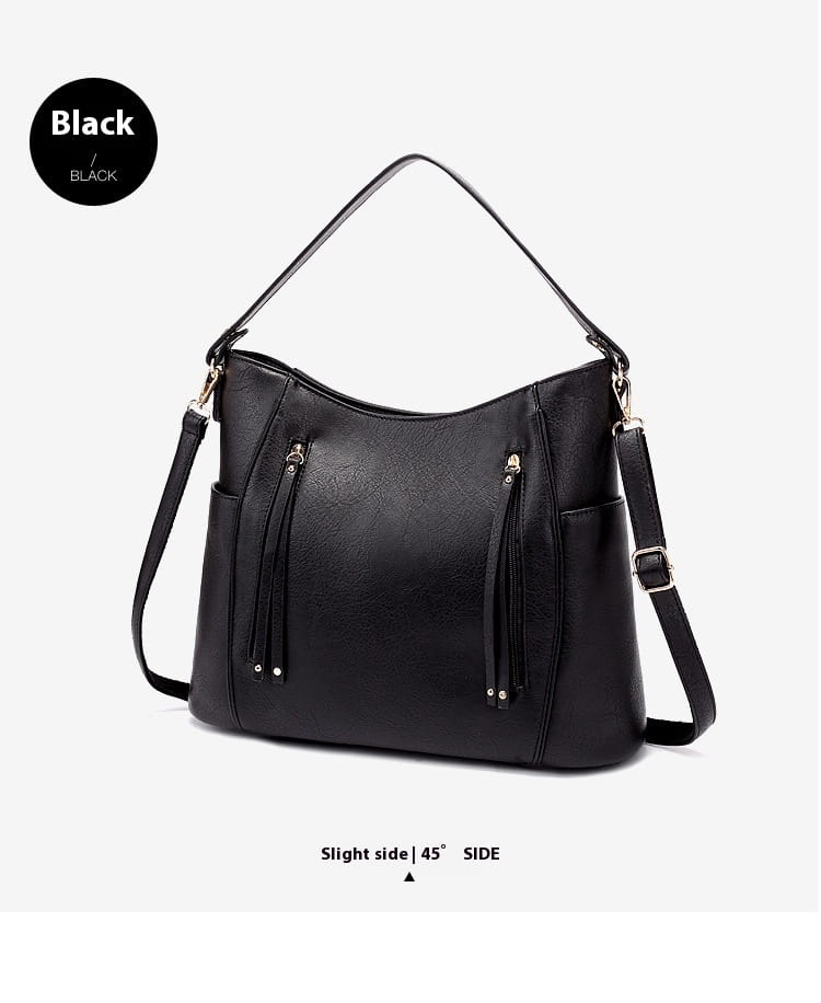 Black faux leather large capacity luxury women leather hobo bag with tassel details and adjustable shoulder strap.