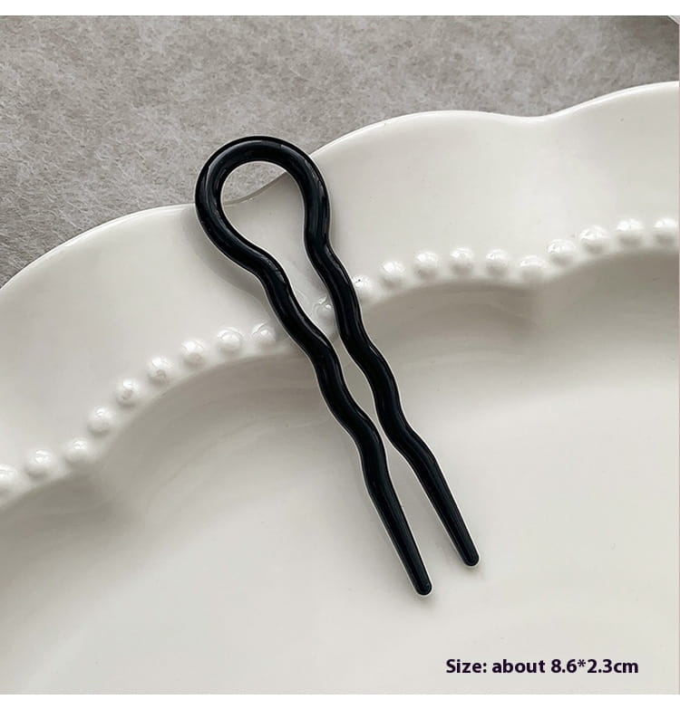 black glossy wavy hair pin with a smooth curved top and two slender prongs designed as a bun lazy updo gadget for head bun lazy hairstyles