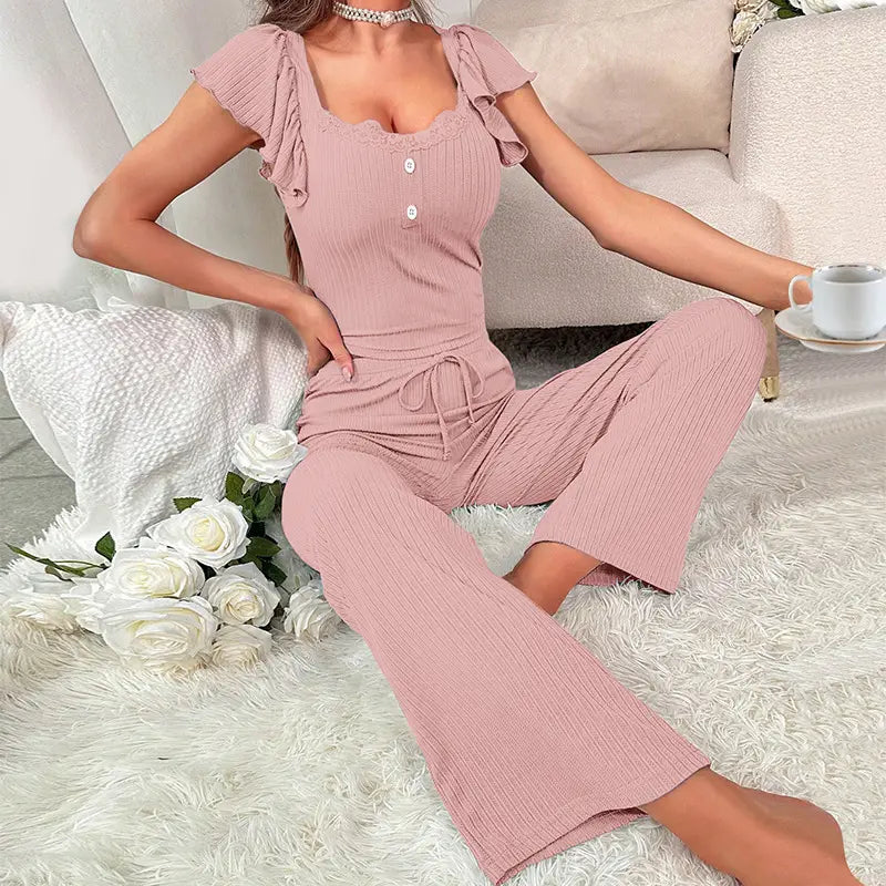soft pink ribbed knit two-piece pajama set with ribbed lace ruffle short sleeves and a drawstring waist for comfortable loungewear.