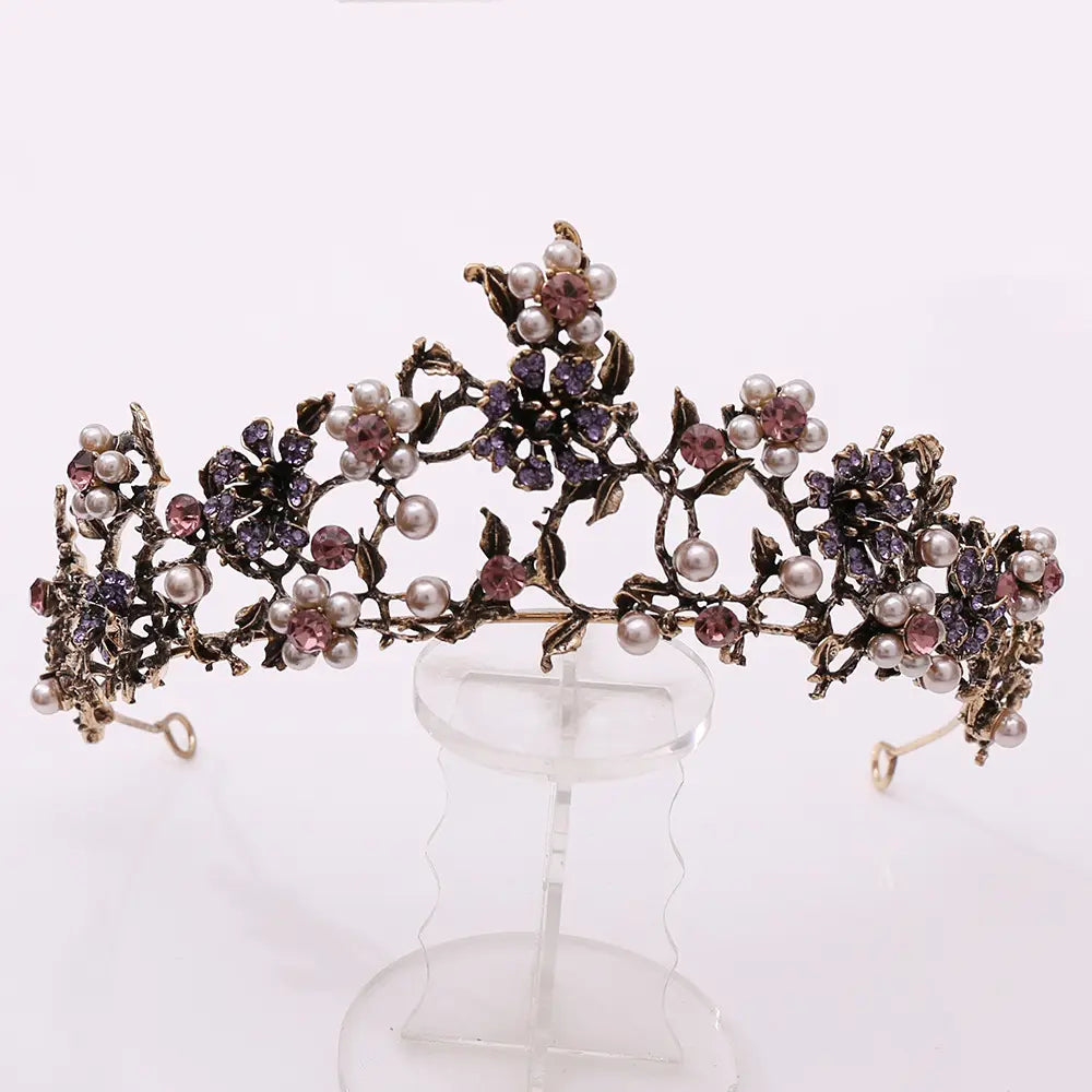 floral black diamond pearl baroque bridal crown with ornate metalwork, white pearls, and sparkling purple and pink gemstones