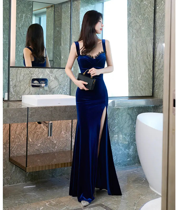 a deep blue velvet lace wrap hip evening dress featuring a fitted bodice with lace trim and a high side slit