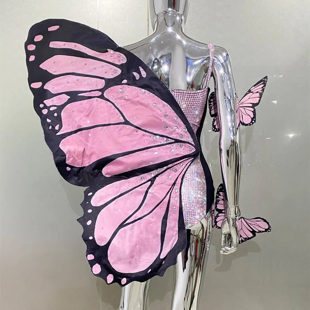 sequin butterfly latin dance skirt dress with pink and black sequined wings on a silver mannequin featuring net yarn stretch material for latin dance performance.