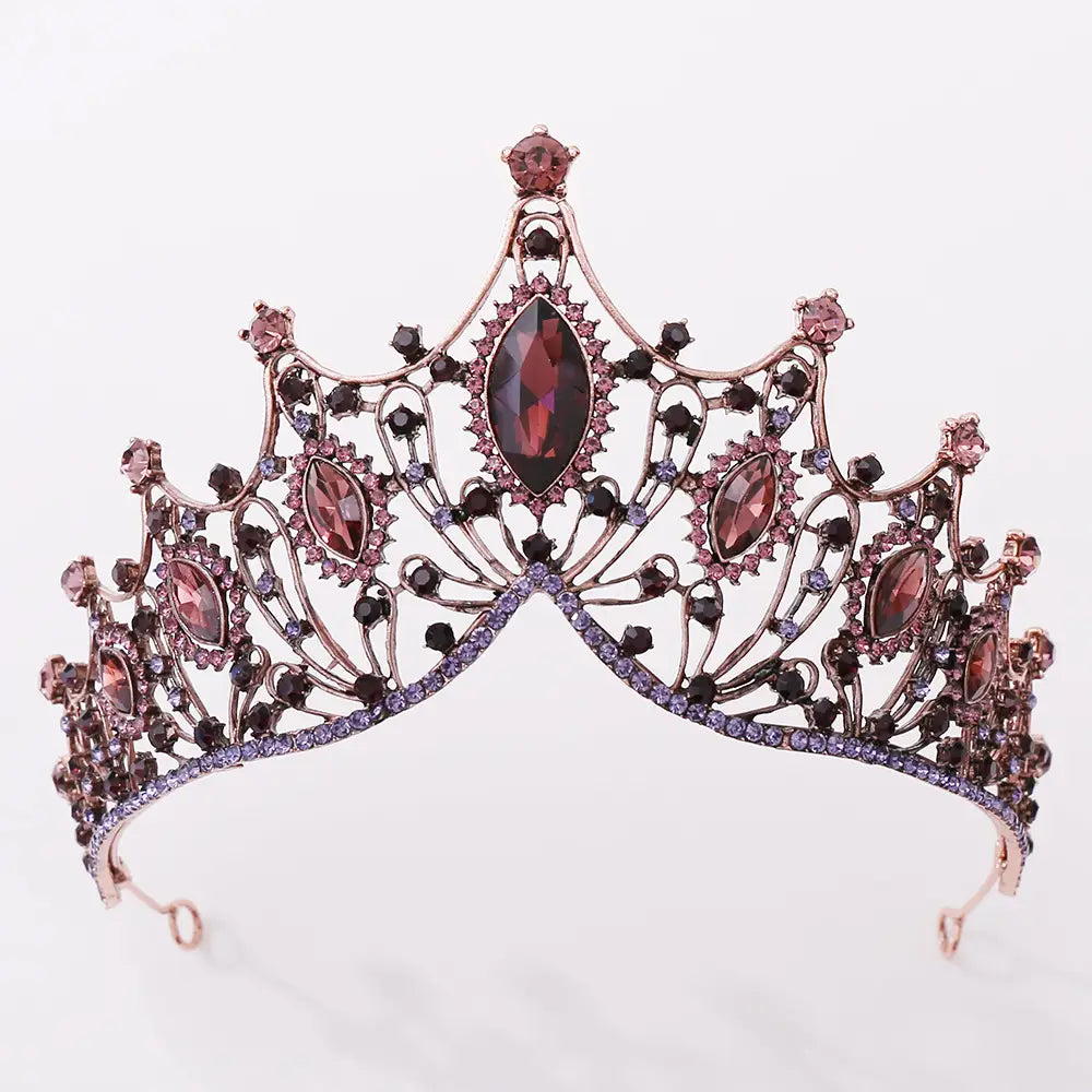 A sparkling rose gold vintage bridal tiara adorned with marquise-cut deep red and black crystals and accented by a row of purple rhinestones along its base.