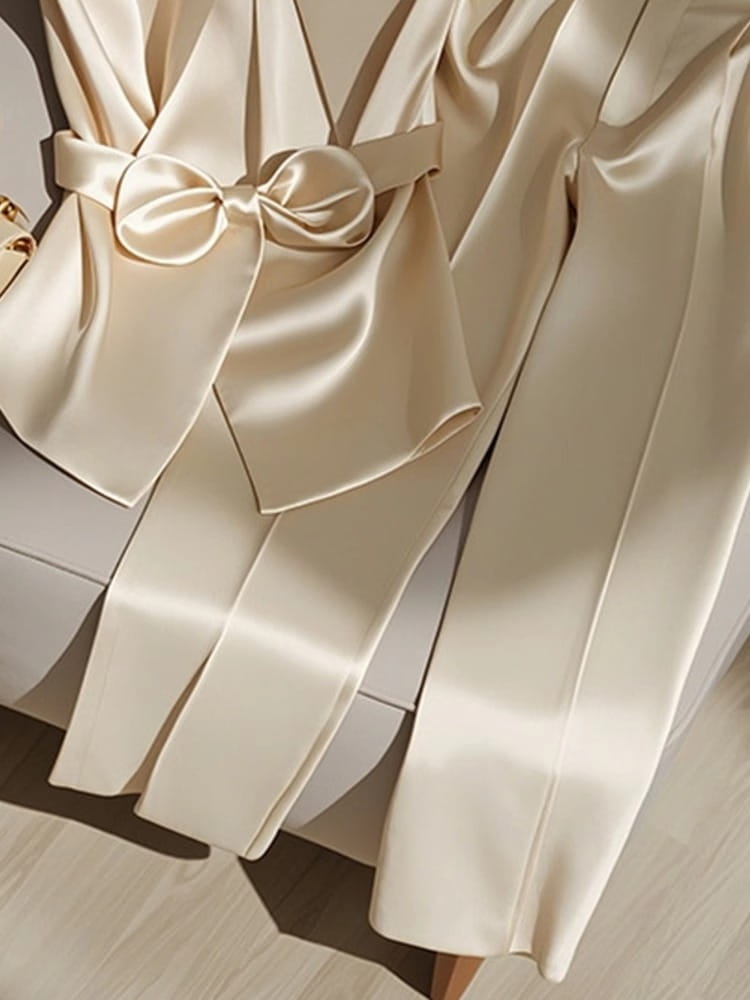 cream-colored satin robe with a matching bow belt showcasing a youthful fashionable champagne style youthful fashionable western style youthful outfit