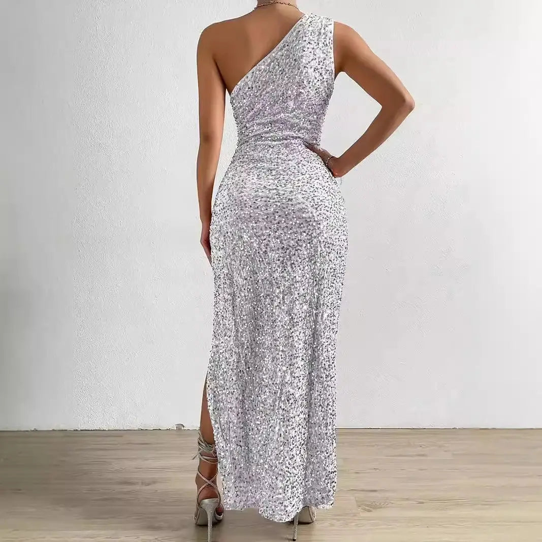 A shimmering silver sequined one-shoulder maxi dress with a high slit and fitted waist from the sexy sequined shoulder sleeping beauty split dress collection.