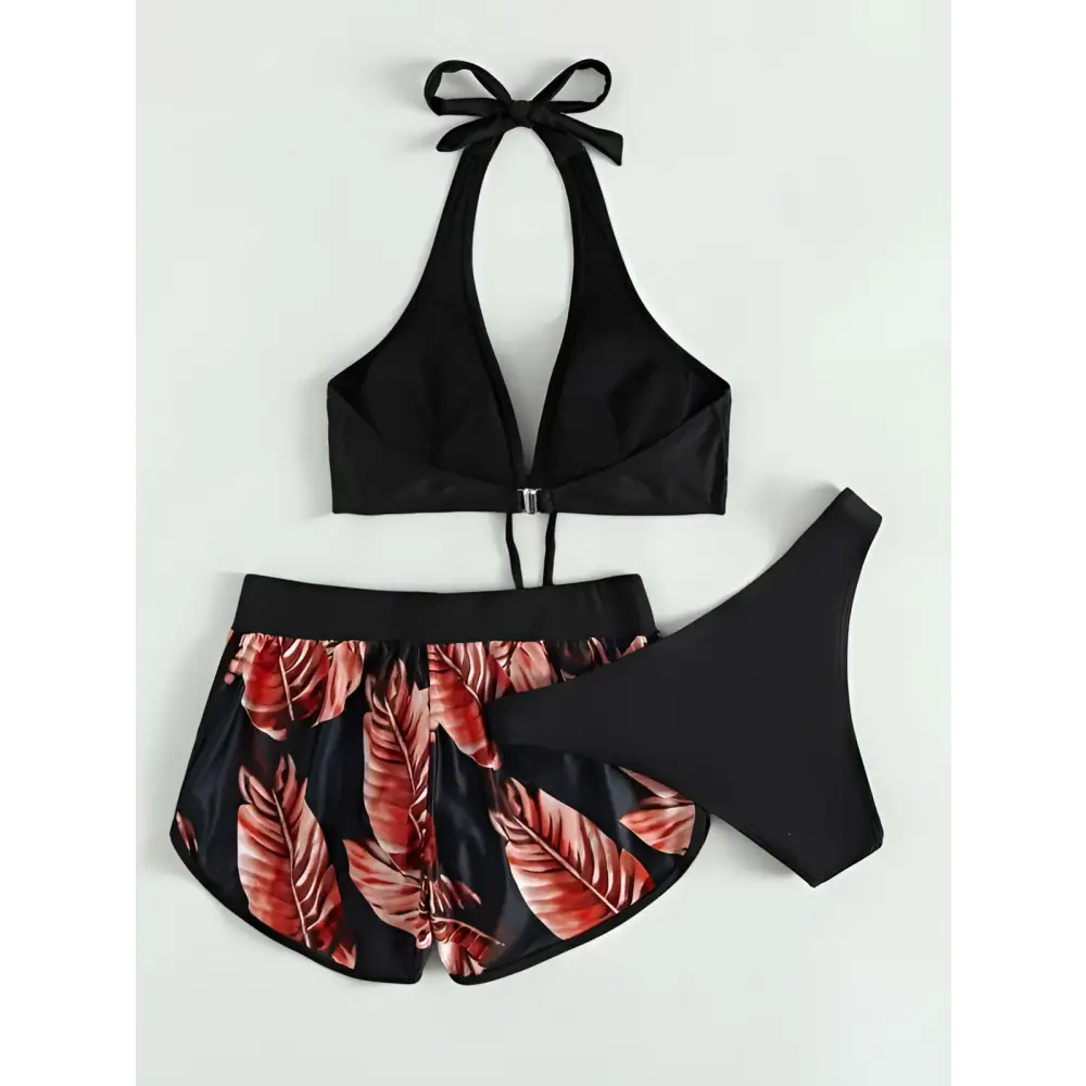 Black halter 3pcs leaf print bikini set with red leaf patterned shorts and matching black bottoms for summer fashion