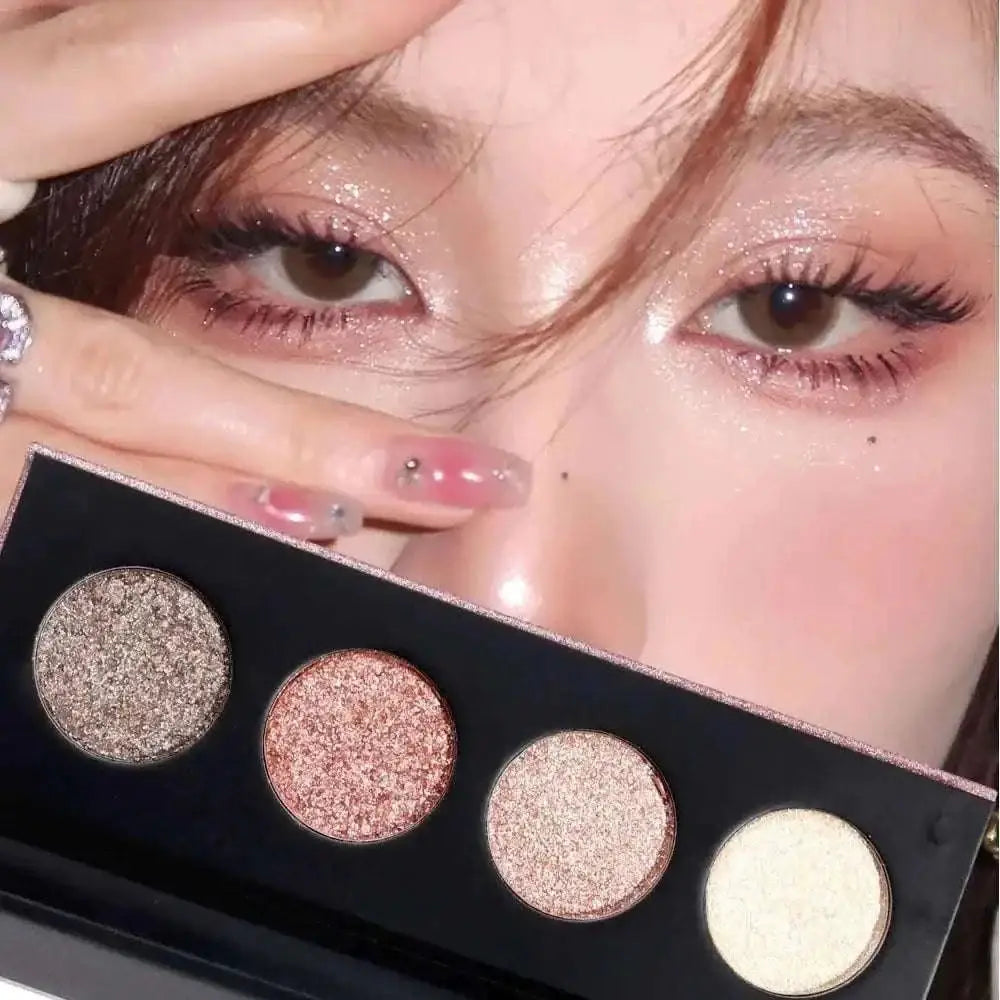 A sleek black 4 color shiny shimmer highlight eyeshadow palette with bronze rose gold champagne and soft white shades
