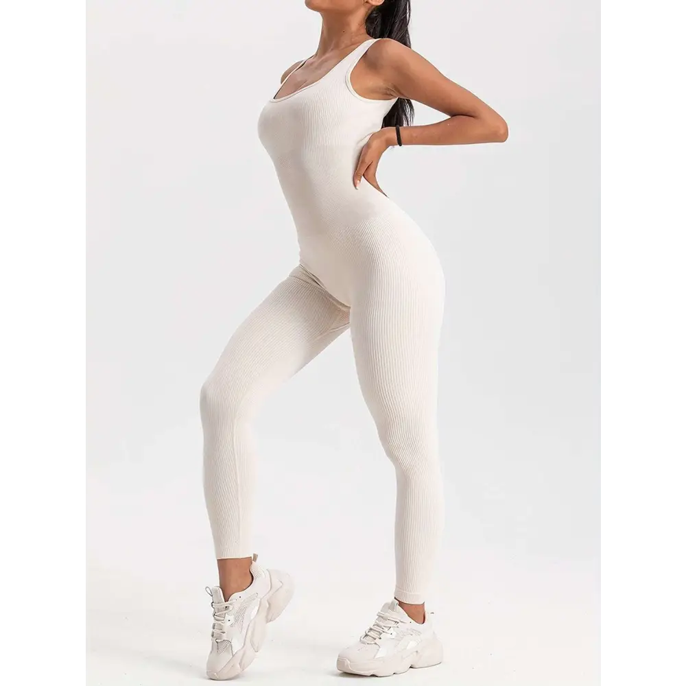 Cream-colored ribbed casual wear bodysuit with scoop neckline and waist curve as part of 4 pack ribbed solid set