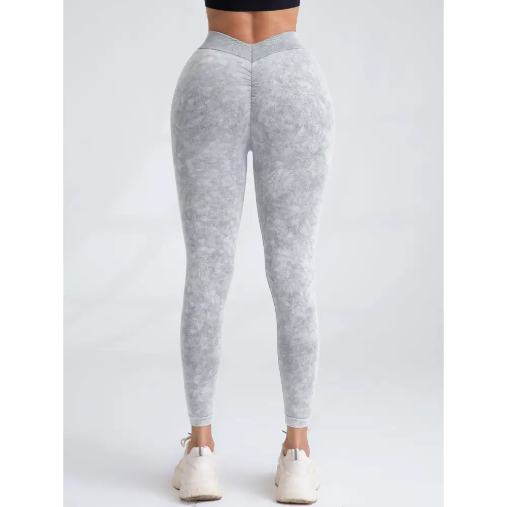 Gray camouflage high-waisted leggings with scrunch butt lifting design elastic waistband shown from the back side