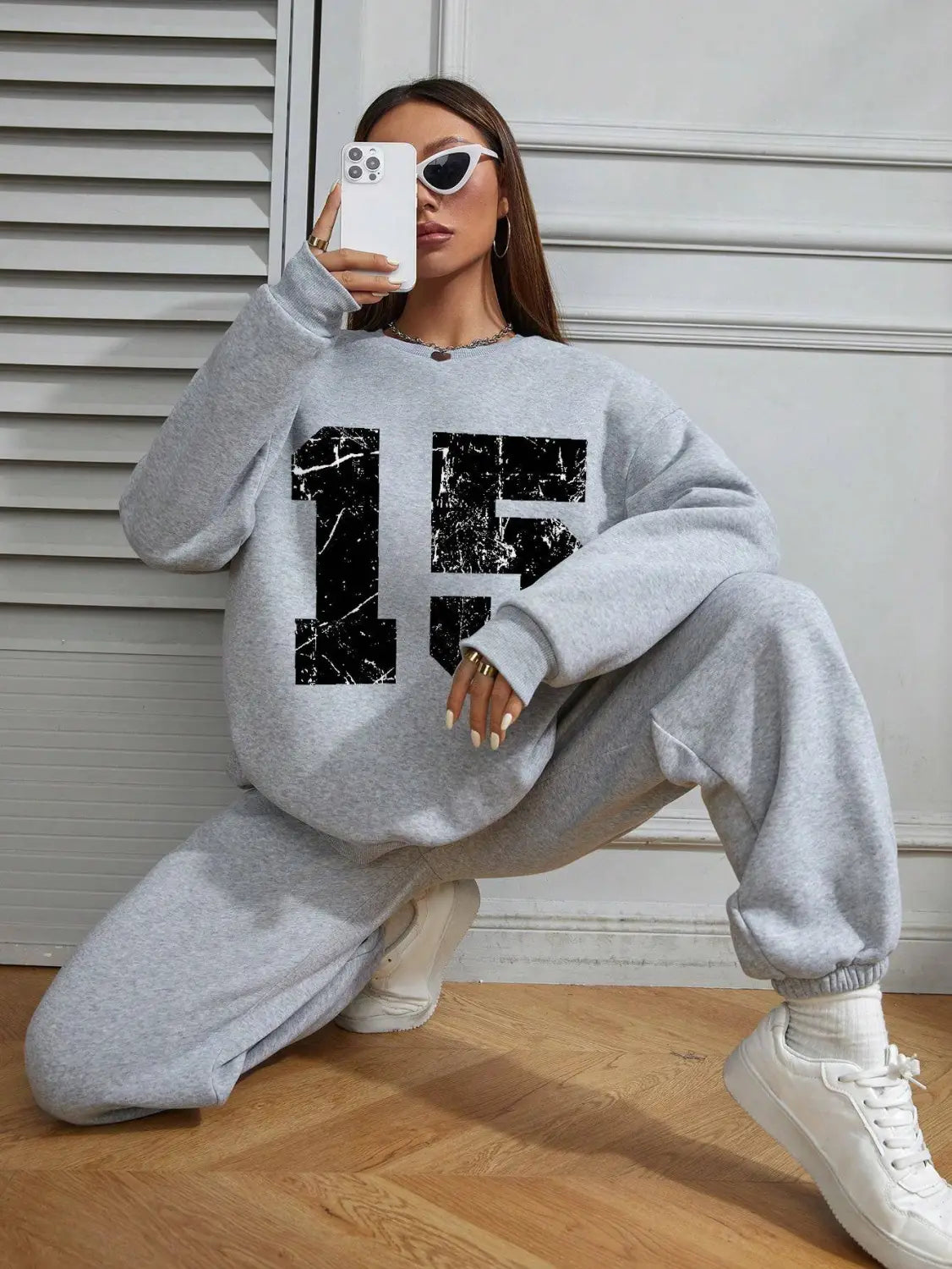 gray crew neck sweatshirt featuring a black distressed 15 graphic on the front, designed for casual wear