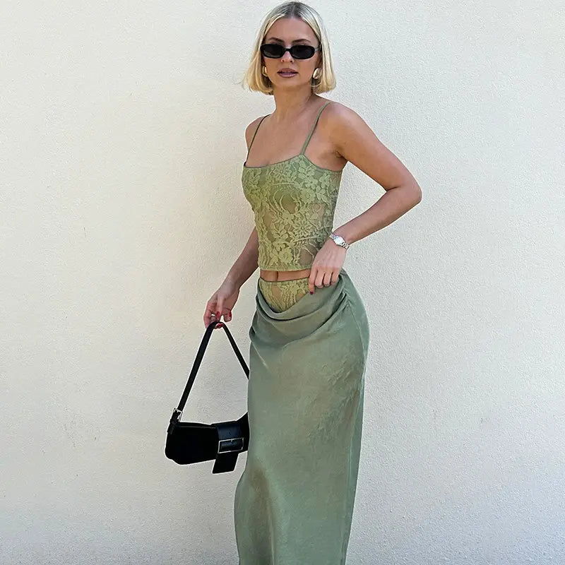olive green lace backless tube crop top with sling stitching ruffle paired with matching satin skirt and black structured handbag featuring stitching ruffle hip design.