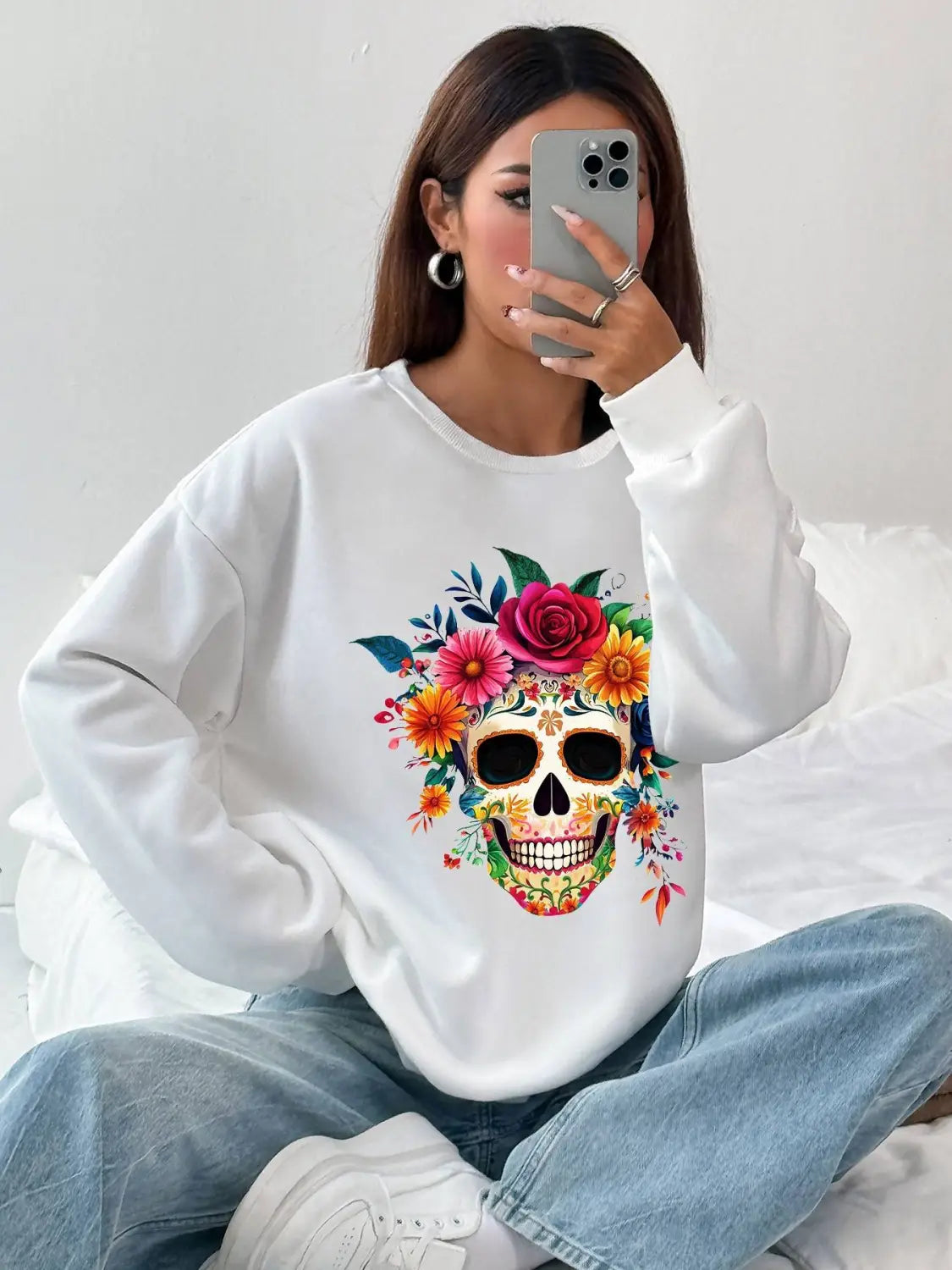 White basic long sleeve crew neck sweatshirt featuring a vibrant colorful floral skull design ideal for daily wear.