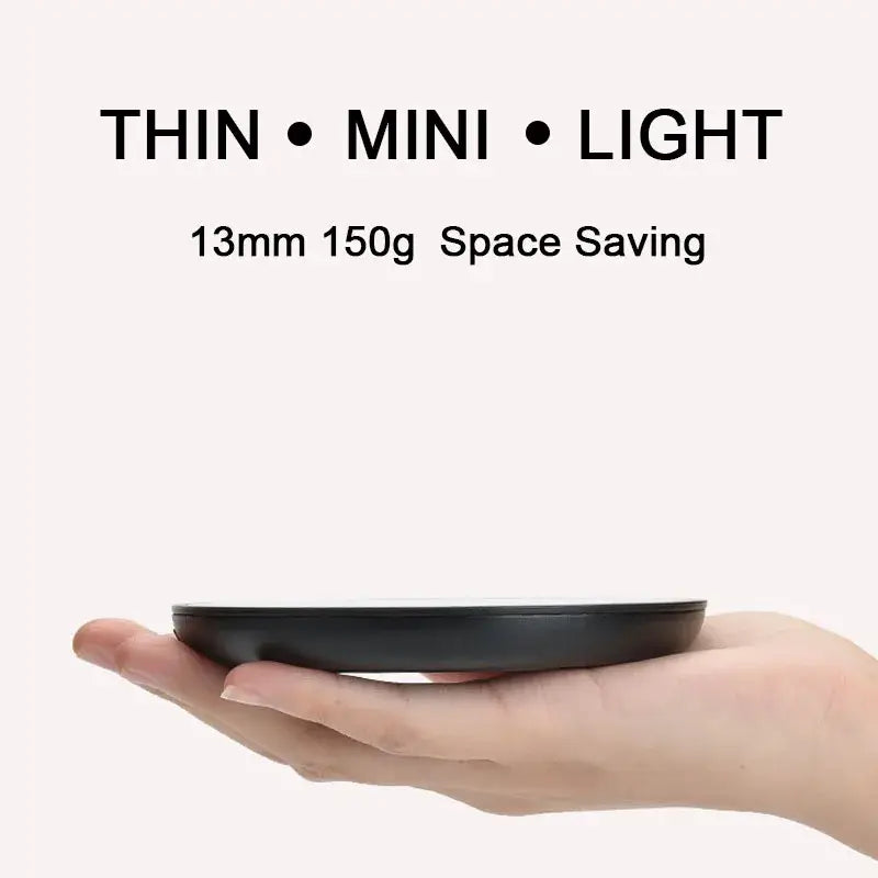 black circular wireless charging pad 13mm thick and 150g in weight designed as a mug cup warmer for tea and coffee
